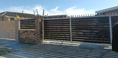 Motorised steel gate at a driveway entrance