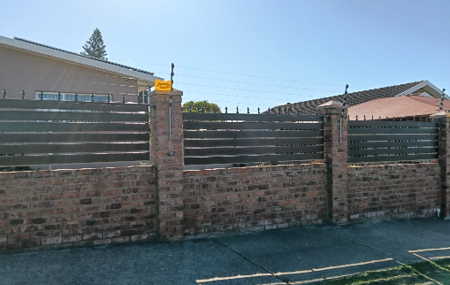 Steel fencing installed on top of a residential wall
