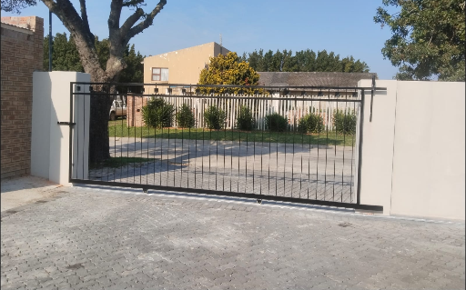 Motorised steel driveway gate at a residential entrance