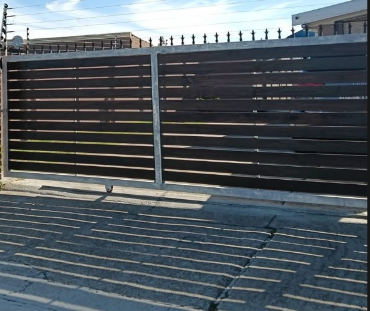 Contemporary black motorised sliding gate