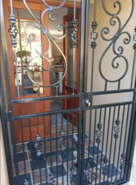 Decorative black steel security gate at a home entrance